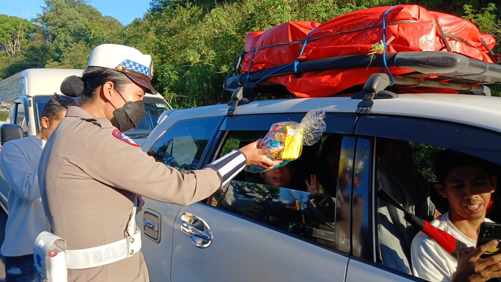 Polwan Polres Tasikmalaya Kota Bagikan Snack untuk Anak-anak di Tengah Arus Balik Lebaran